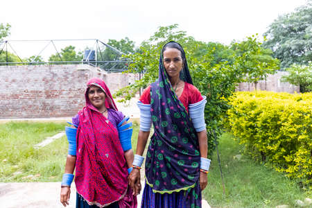 Jawai, Rajasthan, India - September 2021: Portrait of Indian woman working at construction site in ethnic rajasthani dress. Indian labour at working site.のeditorial素材