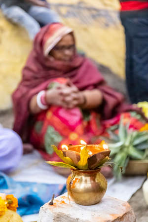 Ghaziabad, Uttar Pradesh, India - November 2021: Chhath Puja, Indian hindu devotees performing rituals of chhath puja during sunrise near river bank.のeditorial素材