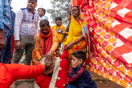 Ghaziabad, Uttar Pradesh, India - November 2021: Chhath Puja, Indian hindu devotees performing rituals of chhath puja during sunrise near river bank.のeditorial素材