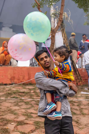Ghaziabad, Uttar Pradesh, India - November 2021: Chhath Puja, Indian hindu devotees performing rituals of chhath puja during sunrise near river bank.のeditorial素材