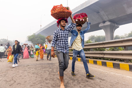 Ghaziabad, Uttar Pradesh, India - November 2021: Chhath Puja, Indian hindu devotees performing rituals of chhath puja during sunrise near river bank.のeditorial素材