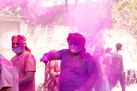 Barsana, Uttar Pradesh, India - March 2022: Portrait on Indian people with color on face celebrating the colorful holi festival on the streets of barsana.のeditorial素材