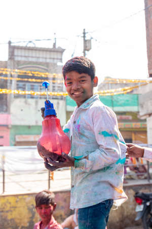 Barsana, Uttar Pradesh, India - March 2022: Portrait on Indian people with color on face celebrating the colorful holi festival on the streets of barsana.のeditorial素材