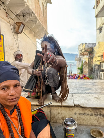 Pushkar, Rajasthan, India - November 2022: Portrait of an old  sadhu baba on the street of Pushkar...