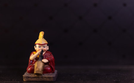 Miniature buddha figurine on black background. Selective focus.の写真素材