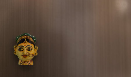 Close-up of a wooden doll on the wall of the houseの写真素材