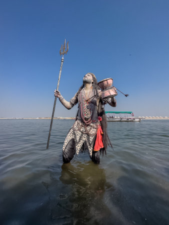 Varanasi, Uttar Pradesh, India - March 2023: Masan Holi, Portrait of an male artist with painted face act as lord shiva during the celebration of masaan holi at harishchandra ghat.のeditorial素材
