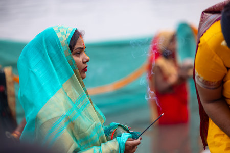 Ghaziabad, Uttar Pradesh, India - October 2022: Chhath Puja, Indian hindu female devotee performing...