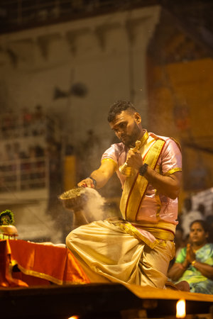 Varanasi, Uttar Pradesh, India - March 03 2023: Ganga aarti, Portrait of young priest performing holy river ganges evening aarti at dashashwamedh ghat in varanasi.のeditorial素材