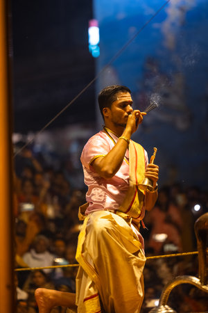Varanasi, Uttar Pradesh, India - March 03 2023: Ganga aarti, Portrait of young priest performing holy river ganges evening aarti at dashashwamedh ghat in varanasi.のeditorial素材