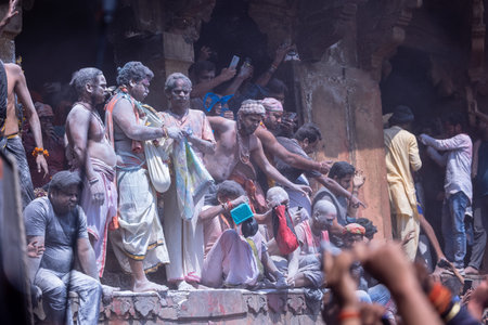Varanasi, Uttar Pradesh, India - March 04 2023: Masan Holi, Group of india people with painted face celebrating the festival of holi at manikarnika ghat with rituals.のeditorial素材