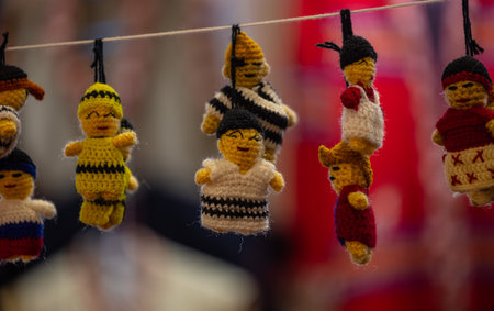 Colorful knitted toy dolls on a rope in the streetの写真素材