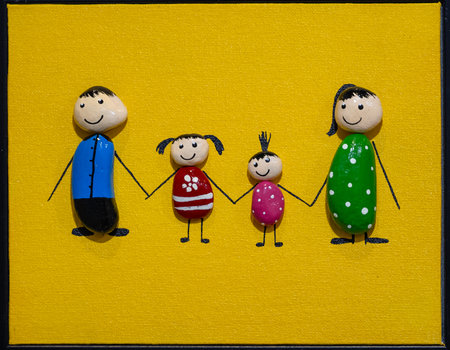 Happy family on yellow background.の写真素材