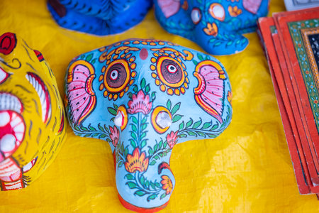 Close up of colorful handmade indian elephant souvenirs on yellow backgroundの写真素材