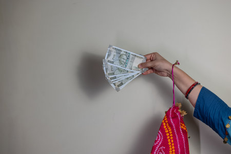 Indian currency with 500 rupees indian note in hand with plain background. Financial concept.