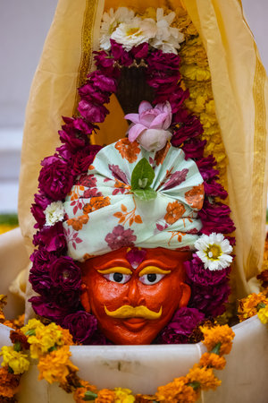 Shivling or shiv lingam decorated with colours and flowers to worship lord shiv. Selective focus.