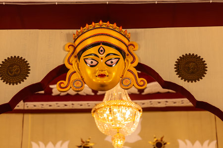 Handmade colorful face mask souvenir hanging on plain black background. Selective focus on object.の写真素材