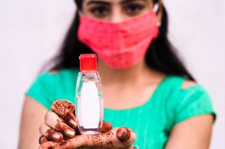 Young girl holding the alcohol  based hand sanitizer gel bottle. Hand sanitizer used to prevent...
