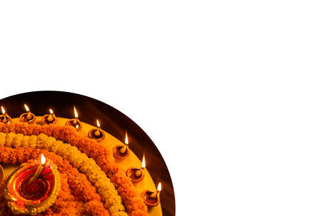 Diwali glowing Diya , flowers, Sweets and Gifts arranged in circular shape forming a design with...