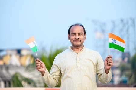 Indian man waving Indian Flags in air and celebrating Independence or Republic day.の写真素材