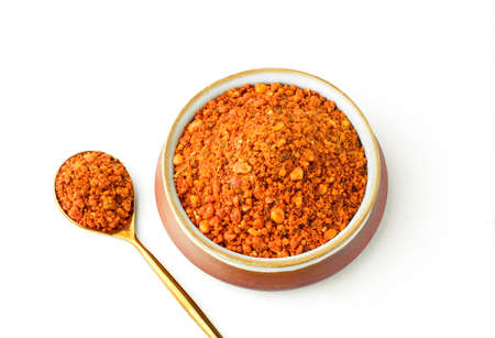 Groundnut chutney pudi or podi, peanut masala powder in a spoon and bowlの写真素材