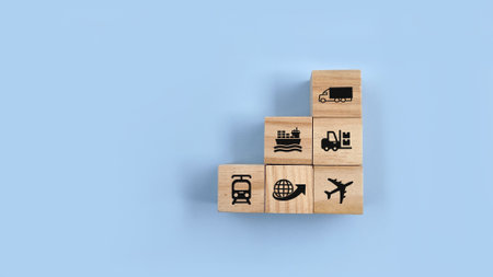 Top view wooden block on blue background with logistic icon. Concept of logistics, delivery or...