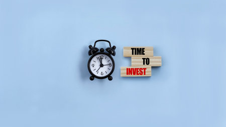 Black alarm on blue background with the time to invest wording. Business and finance conceptの写真素材