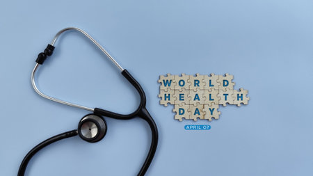 World Health Day 7 April. Stethoscope on blue background with wooden puzzle, text world health day. health conceptの写真素材