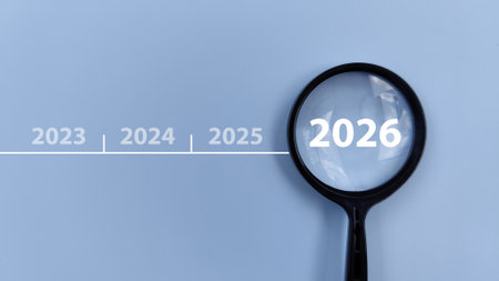 2026 inside of Magnifying glass on blue background. Focus current year, achievement, target concept.の写真素材