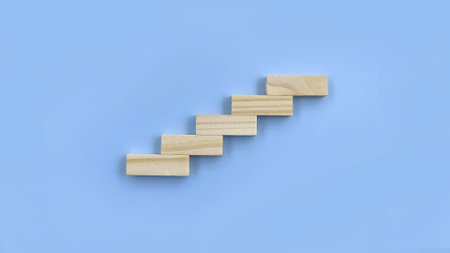 Wooden stairs on a blue background. Business concept of success.の写真素材