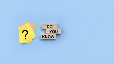 Concept word Do you know on wooden cubes. Question mark on adhesive paper note on blue background. Education conceptの写真素材