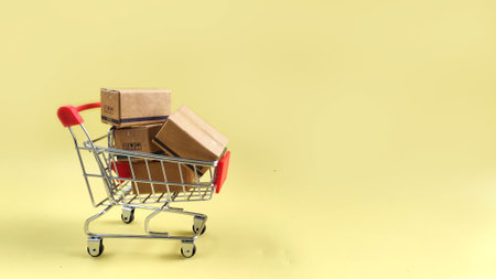 bulk parcel boxes and shopping cart.  logistics, delivery, online shopping conceptの写真素材