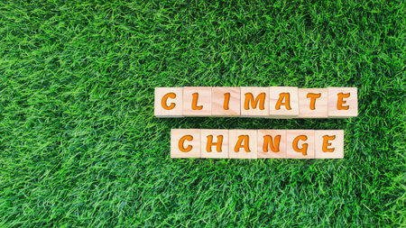 wooden block with CLIMATE CHANGE text on grass background. sustainability, environmental conceptの写真素材