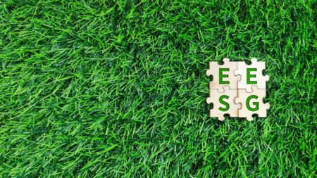 top view wooden puzzle with EESG, economic, environment, social and governance green text on grass background. sustainability, environmental conceptの写真素材