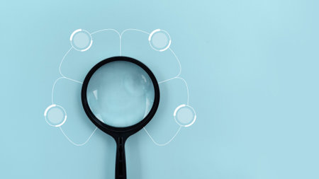 Magnifying glass and blue background. Concept of search and find information.の写真素材