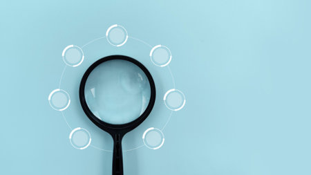 Magnifying glass with white circles on blue background. Top view.の写真素材