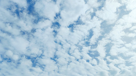 Blue sky filled with soft white clouds creating a calm and peaceful atmosphere.