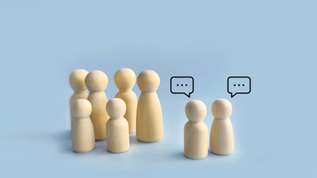 Two groups of wooden peg figures facing each other with speech bubbles, representing negotiation,...