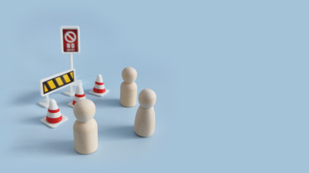 Wooden peg figure near prohibition traffic cone, symbolizing forbidden action, limitation and...