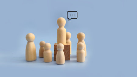 Wooden peg figure standing on a block surrounded by others, symbolizing leadership, authority,...