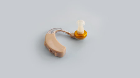 Adult hearing aid isolated on a clean background. Concept of hearing healthcare, accessibility,...