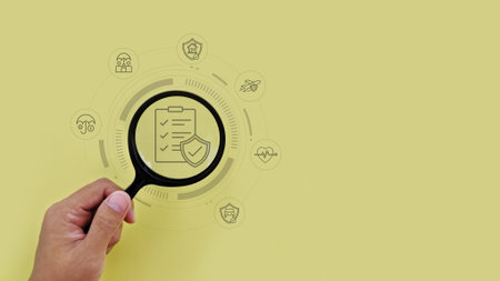 Magnifying glass highlighting types of insurance icons, representing protection, covering areas like...