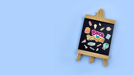 Back to School chalkboard with school supplies stickers on a blue background