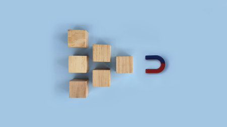 Magnet attracting scattered wooden cubes on blue background, concept of gathering, organization, teamwork, and bringing elements together.
