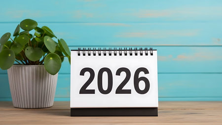 2026 calendar on wooden table with blue background. Happy new year conceptの素材