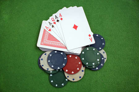 Four of a kind aces on a deck of cards and poker chips