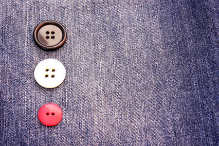 buttons on a gray blue jeans の写真素材