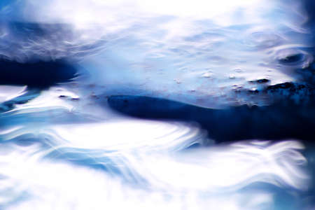 Waves and twists  macro shot of blue liquid soap and water 