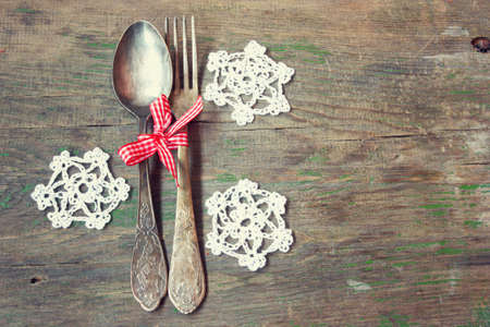 old vintage fork and spoon with knitted snowflakes の写真素材