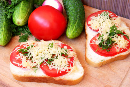 sandwich with tomatoes, cheese and greens の写真素材